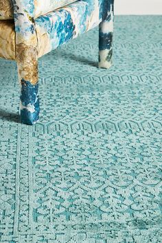 an upholstered bench on a blue carpet