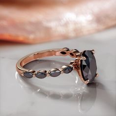 a black diamond ring sitting on top of a table