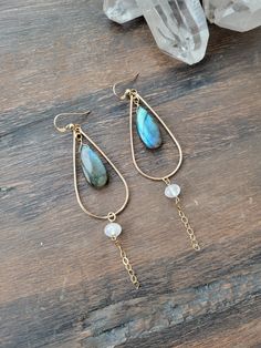 Spellbound Labradorite Earrings with Moonstone. The meaning of spellbound has to do with having your attention fixated as though by a spell or magic! When those colors of Labradorite "flash" it is hard not to stare and be in awe of the beauty and magic of the Labradorite Gemstone! Each teardrop hoop is hand formed and lightly hammered for texture and shape. The length is just a little over 3 in. Each Labradorite is unique, natural, and will vary in color. Some are bluish, greenish, yellowish/orange, or a mix. Please see the 5th picture to see some of the variations. If you have a preference, please message me and I will do my best to accommodate. At the top of the chain is a beautiful petite Moonstone gem. Each piece is handmade and may vary slightly. Thank you! Labradorite Earrings, The Meaning, Earring Necklace, Moonstone, Labradorite, The Beauty, Gold Filled, Flash, Gems