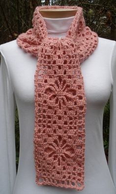 a pink crocheted scarf on top of a white mannequin