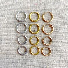 six pairs of gold and silver colored metal rings