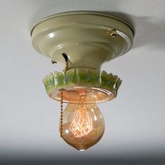 a light that is on the ceiling with a chain hanging from it's side