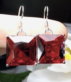 Simulated Red Ruby Earrings  Square Design#E45 Custom Made This is a pair of lovely new Art Nouveau inspired earrings. The gorgeous sterling silver earrings are set with simulated red ruby gems.  These man-made gemstones are approx. 20carat weight in total. These bright gemstones are 15mm by 15mm (9/16") in length and width and the earrings are 1-1/4" long. The earrings are marked 925 for sterling. Notice the beautiful swirl and heart craftsmanship in the filigree settings. The lovely filigree s