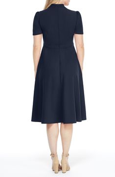 This dainty short sleeve dress is a retro inspired staple that's perfect for any well-dressed occasion. 45" length Necktie Short sleeves Back zip closure Lined 96% polyester, 4% spandex Hand wash, dry flat Imported Model Stats: 5'10" height; 34" bust; 27" waist; 35" hips. Classic Midi Length Dress With Back Zipper, Classic Midi Dress With Back Zipper, Classic Knee-length Dress With Back Zipper, Elegant Cap Sleeve Dress With Back Zipper, Chic Cap Sleeve Formal Dress, Chic Formal Dress With Cap Sleeves, Formal Short Sleeve Midi Dress With Flattering Silhouette, Formal Midi Dress With Flattering Silhouette And Short Sleeves, Fitted Short Sleeve Midi Dress For Evening