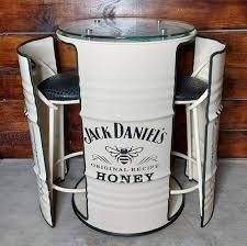 two stools sitting next to a table with a honey jar on the top and bottom