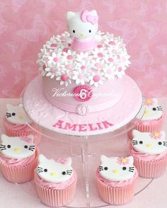 a hello kitty birthday cake with cupcakes