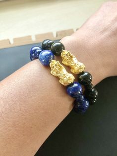 "This is Pure Real 24 Karat Gold Pixiu/Natural Lapis Lazuli Gold Pixiu/Piyao - Approximately 20mm x 10mm (less than 1g) Natural Lapis Lazuli - Approximately 10mm-11mm Approximately 6mm Please select bracelet size. All are handmade with care .Strung on heavy duty stretchy/elastic. Products and photo may differ. Bracelet Comes with Storage Bag & Box How to Determine Bracelet Size: Step 1: Measure your wrist just below the wrist bone, where one would normally wear a bracelet, with a flexible me Gold Hand Wrapped Beaded Bracelets For Meditation, Fishing Bracelet, Cat Bracelet, Lucky Bracelet, Lapis Lazuli Beads, 24 Karat Gold, Red Bracelets, Protection Bracelet, Jade Bracelet