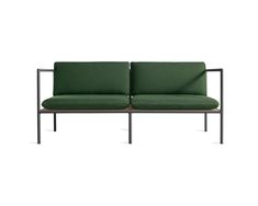 a green couch sitting on top of a metal frame