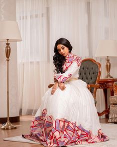 This Habesha dress is a true work of art, made of high-quality Menen fabric that is known for its elegance and beauty. The dress features stunning Mulu Tilf embroidery on the bodice and sleeves, adding a touch of sophistication and class. The tilf embroidery is done in a way that highlights the beauty of the Menen fabric, creating a stunning contrast that is both timeless and modern. The dress is designed with a flattering fit that accentuates the curves, and the flowing skirt adds a graceful to Eritrean Dress, Habesha Dress, Ethiopian Dress, Habesha Kemis, Flowing Skirt, Traditional Outfits, Bodice, The Dress, Highlights