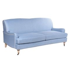 a blue couch sitting on top of a white floor