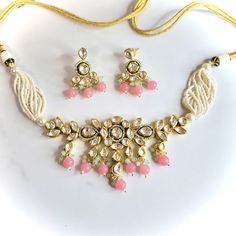 A bright gold and pink kundan necklace set with earrings. Can be worn as a choker or necklace. Pink Chandbali Kundan Necklace For Festivals, Pink Meenakari Jewelry Sets For Party, Pink Chandbali Kundan Necklace For Celebration, Pink Necklace For Diwali Party, Pink Jewelry Sets For Diwali Party, Pink Necklace For Diwali, Pink Kundan Necklace For Festive Celebration, Pink Kundan Choker For Festivals, Festive Pink Kundan Necklace