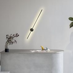 a white table with a yellow banana on it next to a plant and some lights