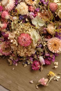 a bunch of dried flowers sitting on top of a table