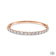 This Oval Diamond Bangle features an exquisite oval-shaped diamond set in a timeless design. Perfectly suited for any occasion, this stunning piece is sure to be treasured for years to come. The standard size is 7 inches; please note any other sizes are considered special order and may require additional time for production. Oval Diamond White Tennis Bracelet, Oval Link Diamond Bracelet For Anniversary, Oval Diamond Bracelet With Diamond Accents, Oval Diamond Bracelet With Accents, Fine Jewelry Oval Diamond Bracelet With Accents, Elegant Oval Link Tennis Bracelet For Anniversary, White Oval Wedding Bracelet, Oval Brilliant Cut Tennis Bracelet For Wedding, Timeless Oval Tennis Bracelet With Diamond Accents