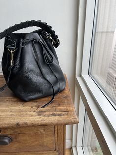 "For more handmade leather bags, purses, satchels, messengers, travel bags, holdalls, carry alls, handbags, shoulder bags, click here: http://etsy.me/1muiXbL. Mini bucket bag is a great little drawstring handbag that is made out of soft cognac leather and bridle leather strap. Its easily opened and closed with the leather drawstring and can fit an iPad mini if stretched opened. The strap is long and will fit most and comes with adjustable leather option. Made to order made from scratch leaving r Luxury Bucket-shape Shoulder Bag For On-the-go, Leather Bucket Satchel For On-the-go, Chic Bucket Bag With Leather Lining For On-the-go, Luxury Crossbody Bucket Bag For Errands, Textured Leather Bucket Bag In Pouch Shape For Everyday, Textured Leather Bucket Bag Pouch For Everyday Use, Bucket Satchel With Detachable Strap For Daily Use, Leather Crossbody Bucket Bag For On-the-go, Luxury Satchel Bucket Bag