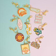 several different key chains on a blue and pink background