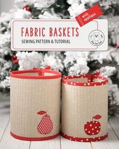 two fabric baskets sitting next to a christmas tree