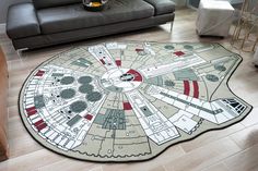 a living room area rug with a star wars millennium model on the floor in front of a couch