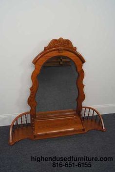 a wooden shelf with a mirror on top of it