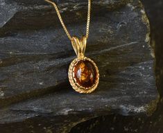 Gold Amber Pendant set with Natural Amber in the highest quality & brownish-yellow translucent resin, at 10x8mm, 3 Carats, sourced from Russia. Gold Dainty Pendant in Vintage design made of Gold Vermeil ☞ thickest 18k Gold Plating on top of Solid 925 Sterling Silver ☞ made to last. Free Gold Vermeil Chain with every Pendant order, 18 inch Silver chain (46 cm) ✓ Matching Ring & Earrings - please ask me ⌛Last Pendant left ⌛ ❀ Each Natural Gem is unique & will have Slight variations from the produc 14k Gold Oval Amber Jewelry, Polished 14k Gold Amber Jewelry, Amber Jewelry With Polished Finish For Anniversary, 14k Gold Amber Jewelry With Polished Finish, Classic 14k Gold Amber Jewelry, Elegant Amber Oval Cabochon Necklace, Classic Amber Oval Cabochon Jewelry, Classic Round Pendant Cabochon Jewelry, Oval Amber Jewelry For Formal Occasions