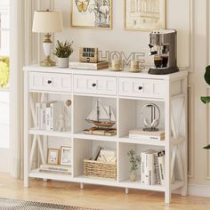 a white bookcase with books and pictures on the wall next to a coffee maker