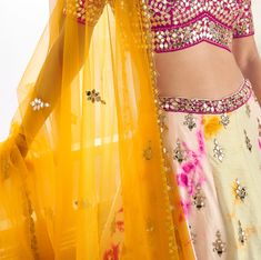 COLOR : Cream Yellow & Magenta FABRIC : Top (Blouse) - Premium Silk, Bottom (Lehenga) - Premium Silk, Inner - Cancan, Dupatta - Net WORK : Foil, Gota Work, Sequins, Digital Print, Motifs, Lace Border OCCASION : Wedding, Reception, Sangeet, Engagement READY-TO-WEAR : NoSTITCHING : Available as semi-stitched fabric, can be stitched using standard size option (+$30). Note: There might be a slight color variation due to lighting and flash used during photoshoot. The bright shade seen is the best clo Magenta Wedding, Holiday Promotions, Wedding Lehenga, Lace Border, Lehenga Choli, Embroidered Silk, Formal Occasion, Lehenga, Color Variations