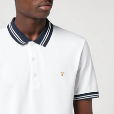 Originally founded as workwear in 1920s Texas, Farah had a British revival in the ‘70s that saw it become synonymous with the Mod and Indie scenes. Crafted from white cotton-piqué, the slim-fitting Stanton polo shirt is framed with contrast navy trims and signature gold embroidery to the chest.100% Organic CottonModel is 188cm/6'2' and wears a size L. White Cotton Polo Shirt With Striped Collar, Classic White Polo Shirt With Contrast Collar, Spring Cotton Polo Shirt With Contrast Collar, Classic White Cotton Polo Shirt, White Cotton Polo Shirt With Ribbed Collar, White Polo Shirt With Striped Collar For Workwear, White Cotton Collared Polo Shirt, White Polo Shirt With Striped Collar For Spring, Spring White Polo Shirt With Striped Collar