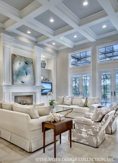 a living room filled with lots of furniture next to a fire place in a house