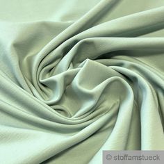 a close up shot of a plain light green fabric