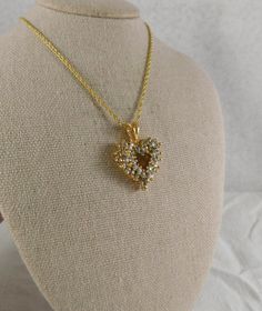 Sparkling CZ's adorn this beautiful openwork gold plate heart necklace made by Roman's. . Pendant is 1 by 3/4 inches and the chain is 18. 43 cz's...none missing. Stamped "Roman" on the back of the bail of the pendant. It does not have the original chain on itvery slight difference in shades of gold. Beautiful pristine condition.  SHIPS TO US LOCALES/MEXICO/CANADA/AUSTRALIA & NZ ONLY. Cubic Zirconia Heart Pendant Jewelry With Heart Beads, Gold Cubic Zirconia Heart Pendant Necklace, Heart Beads Cubic Zirconia Jewelry For Gifts, Cubic Zirconia Heart Beads Jewelry Gift, Cubic Zirconia Jewelry With Heart Beads For Gift, Gold Heart Pendant Necklace With Cubic Zirconia, Gold Heart Necklace For Anniversary, Elegant Open Heart Necklace For Jewelry Making, Wedding Heart Necklace With Birthstone Pendant