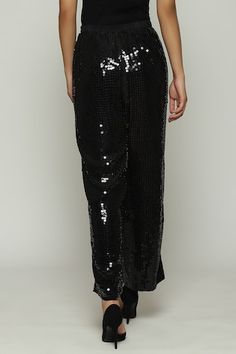 Black straight fit pant with tonal sequin embellishments. - Aza Fashions Festive Embellished Straight Pants, Black Sequin Pants For Party, Festive Embellished Wide Leg Pants, Festive Embellished Wide-leg Bottoms, Festive Wide-leg Sequin Pants, Festive Workwear Straight Pants, Festive Wide Leg Embellished Pants, Black Embellished Wide Leg Bottoms, Festive Wide Leg Sequin Pants