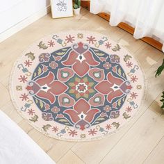 a round rug is on the floor next to a potted plant