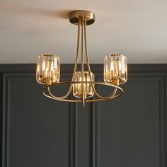 a chandelier hanging from the ceiling in a room with dark walls and green paneling