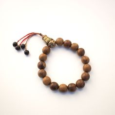 Approximately 12mm round wood beads and vintage Tibetan brass beads wrist mala Fits wrist sizes 7 to 8 Spiritual Stretch Bracelet With Wooden Beads For Meditation, Spiritual Wooden Beads Stretch Bracelet For Meditation, Traditional Adjustable Wooden Beads Stretch Bracelet, Brown Wooden Beads Bracelet, Spiritual Brown Bracelets With Wooden Beads, Traditional Adjustable Beaded Bracelets With Wooden Beads, Traditional Adjustable Wooden Beaded Bracelets, Adjustable Traditional Beaded Bracelet With Wooden Beads, Adjustable Traditional Wooden Beaded Bracelets