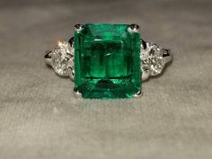 GORGEOUS 14K white gold emerald  engagement ringcenter Lab Flux Growth EMERALD COLOMBIA BERYL EMERALD weight 3.18ct. size 10.7X9.4X3.9mmnice vivid green color ,clean, very lively ,nice cut .side two round diamonds total weight 0.85ct H-SI1Ring SIZE 6.5Resizable Retail value $8,500 net.Cert Appraisal available Gia Certified Green Princess Cut Diamond Ring, Gia Certified Green Princess Cut Rings, Green Diamond Ring With Vvs Clarity And Radiant Cut, Gia Certified Green Emerald Ring In Platinum, Gia Certified Green Emerald Platinum Ring, Radiant Cut Green Emerald Ring In Platinum, Green Asscher Cut Diamond Ring In Platinum, Platinum Emerald Ring With Radiant Cut, Green Asscher-cut Platinum Diamond Ring