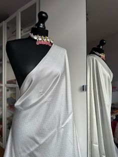 White and silver soft silk saree with an all over sheen. The perfect saree for parties and all traditional events. Versatile saree that can be styled with other blouses or same colour as saree. Message us for personalised bridesmaid saree quotes.   Blouse: unstitched, same fabric and colour as saree   #whitesaree #silversaree #whitesoftysilk   #silksareelook #softsilksaree #sareetrends #kuberapattu Festive Silver Pre-draped Saree With Unstitched Blouse, Traditional Silver Pre-draped Saree With Pallu, White Self-design Saree For Party, Silver Bollywood Pre-draped Saree For Festive Occasions, Festive Silver Bollywood Pre-draped Saree, Silver Pre-draped Saree With Unstitched Blouse For Festive Occasions, Elegant Silver Pre-draped Saree With Unstitched Blouse, Festive Silver Pre-draped Saree, Silver Pre-draped Saree With Zari Work For Festive Occasion