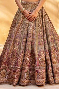 Dusty pink lehenga in raw silk featuring all over Mughal gardenia embroidery with contrasting resham work, gold sequins, dabka detailing, and fine gota stripes. Paired with a half sleeves padded blouse and scallop border embroidered net dupatta., Fit: Relaxed Traditional Festive Dresses With Intricate Design, Traditional Floor-length Dress With Intricate Design, Festive Dresses With Traditional Drape And Intricate Design, Traditional Floor-length Dupatta With Intricate Design, Pink Embroidered Sharara For Traditional Ceremonies, Embroidered Pink Sharara For Traditional Ceremonies, Traditional Pink Choli For Wedding, Pink Gown With Intricate Embroidery For Traditional Ceremonies, Elegant Pink Sets For Traditional Ceremonies