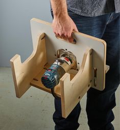 a man is holding a drill holder with two tools in it's center and the other side open