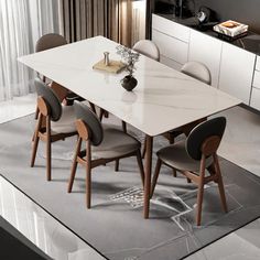 a dining room table with chairs and a vase on the counter top in front of it