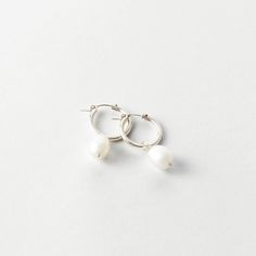 A classic hoop with a statement pearl. Dress them up or down. Everyday White Pearl Pendant Earrings, Everyday Pearl Charm Hoop Earrings, Everyday White Pearl Drop Earrings, Classic Small Hoop Pearl Jewelry, Everyday Pearl Hoop Jewelry, Small Hoop Pearl Earrings, Everyday Pearl Earrings With Pearl Charm, Everyday Pearl Charm Earrings, White Pearl Minimalist Hoop Earrings