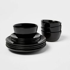 black dishes are stacked on top of each other