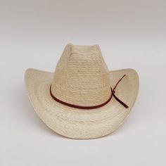 The Meadow straw cowboy hat is lightweight, durable. It's the prefect summer hat for a day at the beach or while cruising around town. These hats are individually handcrafted with sustainable palm leaf and naturally tanned leather by artisans in Guerrero, Mexico, in a fair trade environment. Each hat is unique and may vary in size and color and have small imperfections. -Crown height: 5.0", Brim length: 4.0" curved up brim -Removable naturally tanned brown leather band***leather band may vary fr Natural Hat Band With Flat Brim For Country Events, Adjustable Natural Panama Hat For Ranch, Flat Brim Natural Hat For Ranch, Handwoven Natural Sun Hat For Rodeo, Handwoven Natural Color Sun Hat For Rodeo, Artisan Fedora For Summer Rodeo, Artisan Style Fedora For Summer Rodeo, Artisan Summer Fedora For Rodeo, Casual Natural Straw Hat For Western Style