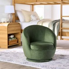 a green chair sitting on top of a rug in front of a bunk bed next to a dresser