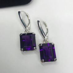 "Gorgeous Amethyst Lever-back Earrings & Pendant Necklace Set Earrings * Emerald Cut Amethyst measure 12x10mm Each * 11cts total Gemstone weight * Shield Design Lever-back Fasteners * Solid Sterling Silver Pendant Necklace * 5.5ct Emerald Cut Amethyst measures 12mm x 10mm * Solid Sterling Silver * 18\" Sterling Silver Chain Included Hallmarked & Gift Ready! Matching Ring also Available! These Amethyst are Laboratory Grown. They are identical to natural stone in every way, including Chemi Purple Amethyst Earrings, Fine Art Jewelry, Sterling Silver Necklace Pendants, Amethyst Earrings, February Birth Stone, Silver Pendant Necklace, Purple Amethyst, Sterling Earrings, Jewelry Trends