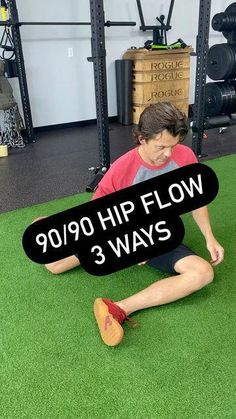 a young boy sitting on the ground holding a sign that says 90 / 90 hip flow 3 ways