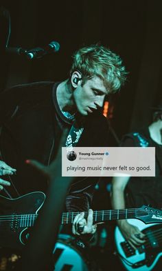 two young men playing guitar and singing into microphones