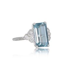 This lovely gemstone engagement ring features a 2.50 carat rectangular aquamarine with an emerald cut. Set in a handcrafted platinum mounting, the gemstone is set between three diamonds on either side. Fine milgrain finish off the bezels of this vintage ring. ✦ AQUAMARINE SPECIFICATIONS: Aquamarine Weight 2.50 Carats ✦ ENGAGEMENT RING SPECIFICATIONS: Ring Material: Platinum Stones: Aquamarine ✦ WHAT COMES IN YOUR SHIPMENT: - Your Engagement Ring - Quality Ring Box - Jewelry Cleaner - UGL Certifi Design Engagement Ring, Estate Diamond Jewelry, Belt Ring, Gemstone Engagement Ring, Gemstone Engagement, Box Jewelry, Gemstone Engagement Rings, Jewelry Cleaner, Designer Engagement Rings