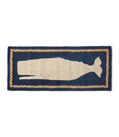 a blue and white rug with a whale on it's side, in the shape of a fish