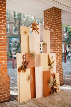 an art installation made out of cardboard with leaves on it