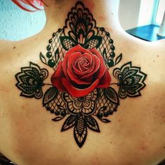 a woman with a rose tattoo on her back